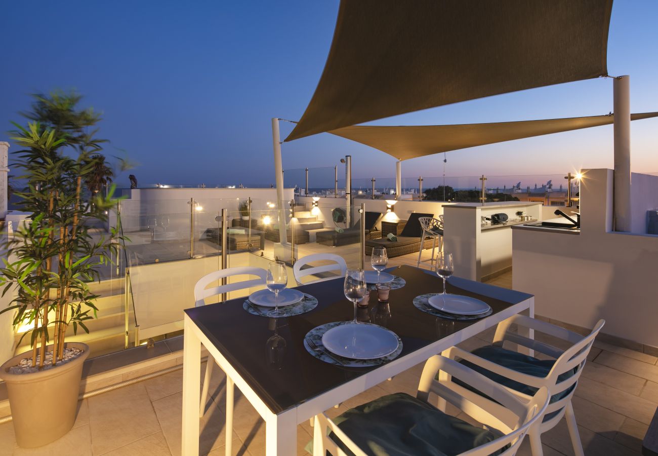 Dining area roof terrace Casa Milhafre Benagil at night