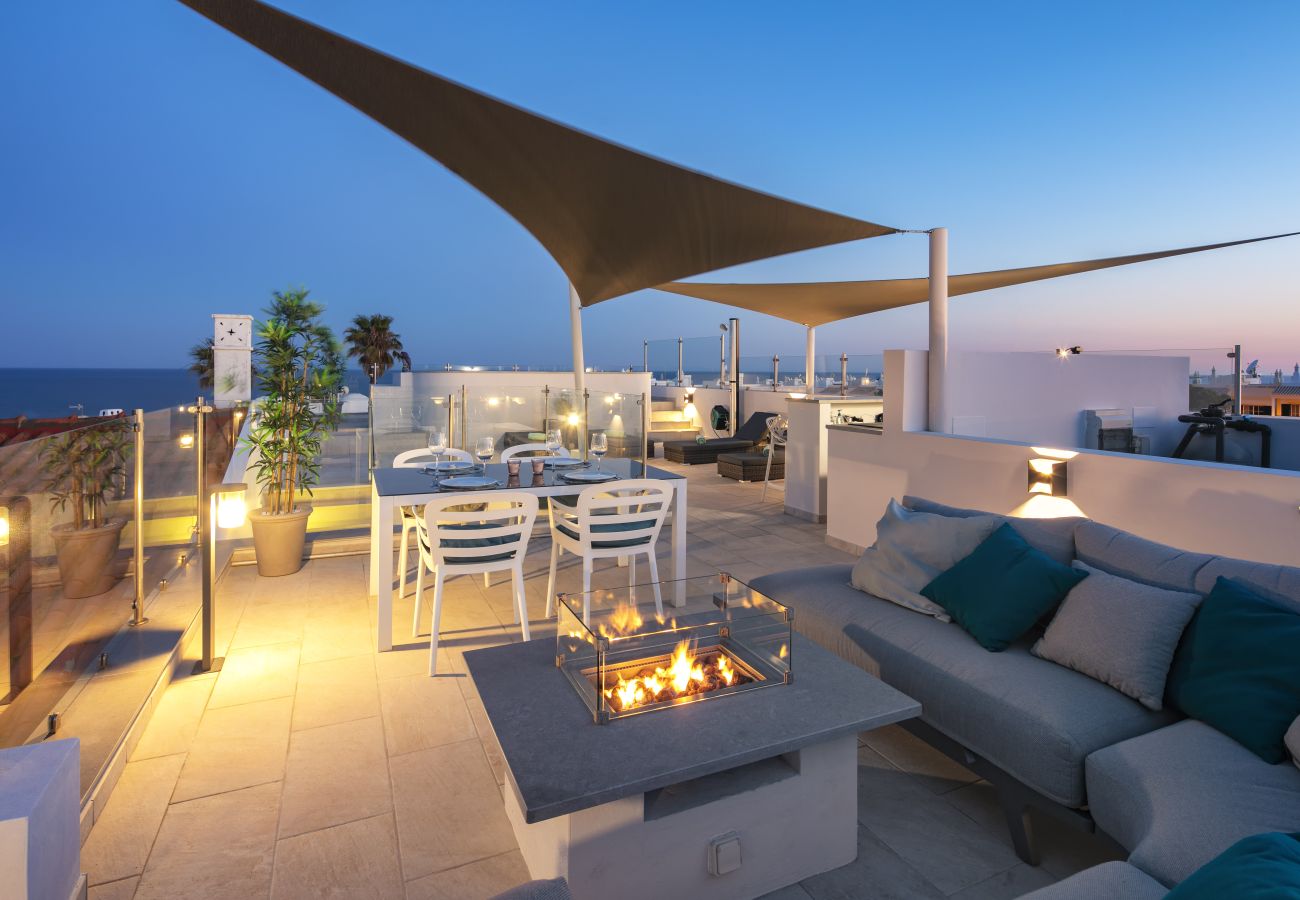 Lounge area with fire pit roof terrace Casa Milhafre Benagil at night