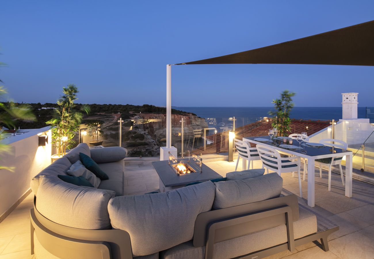 Lounge area with fire pit Casa Milhafre Benagil roof terrace at night